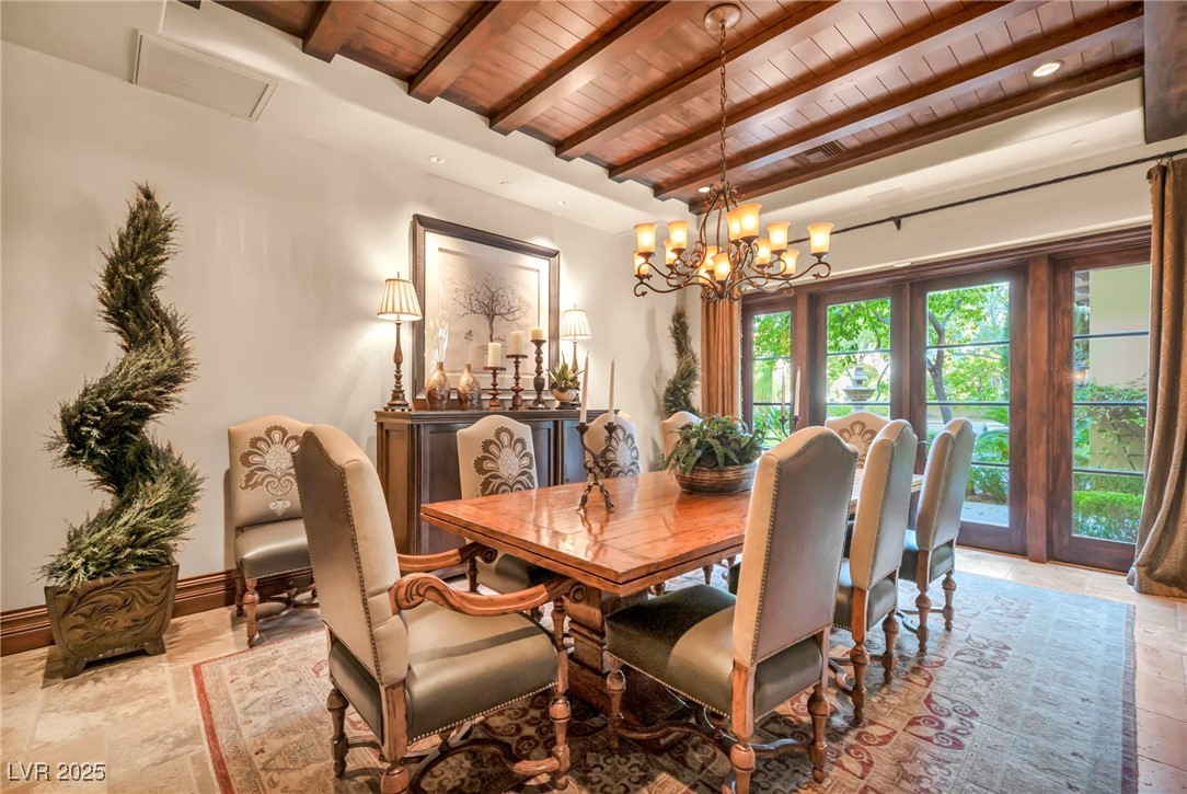 1793 Anelli Court Henderson, NV 89012 - Photo 4 of 47 Dining space with a wood ceiling with exposed beams, stone tile flooring, and a chandelier