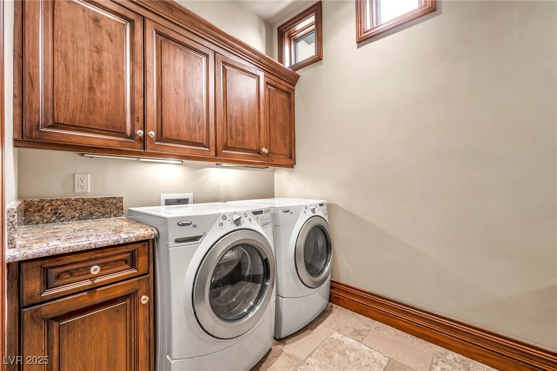 1793 Anelli Court Henderson, NV 89012 - Photo 44 of 47 Laundry room featuring cabinet space, washer and clothes dryer, and stone tile flooring