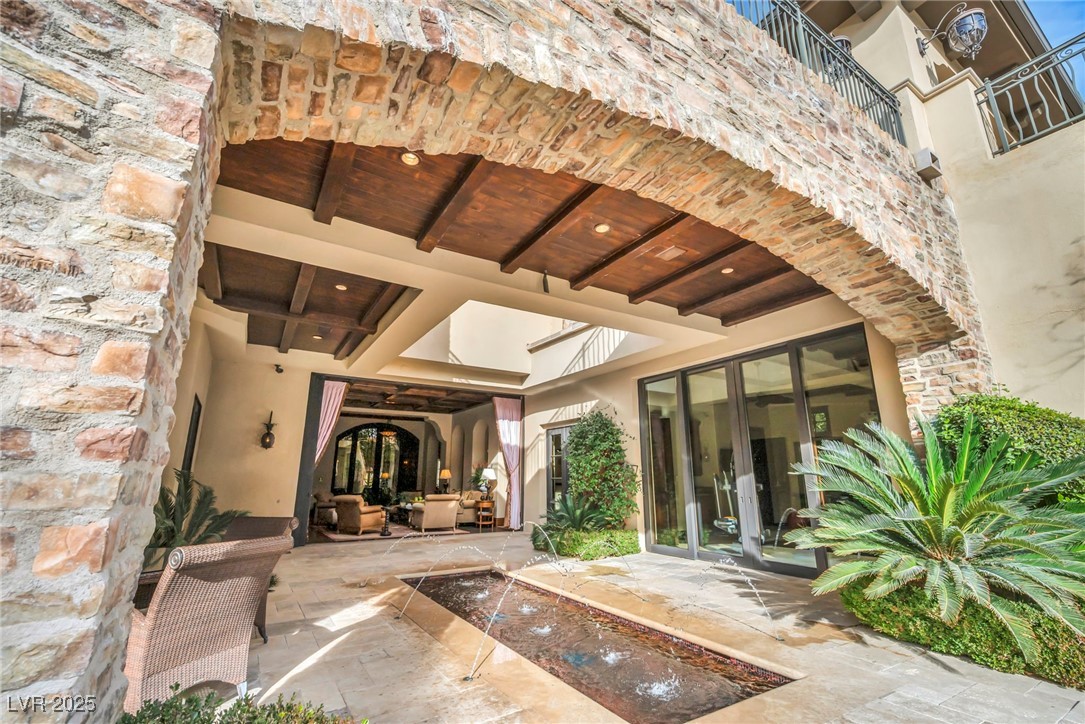 1793 Anelli Court Henderson, NV 89012 - Photo 9 of 47 Entrance to property featuring stone siding, french doors, and a patio area