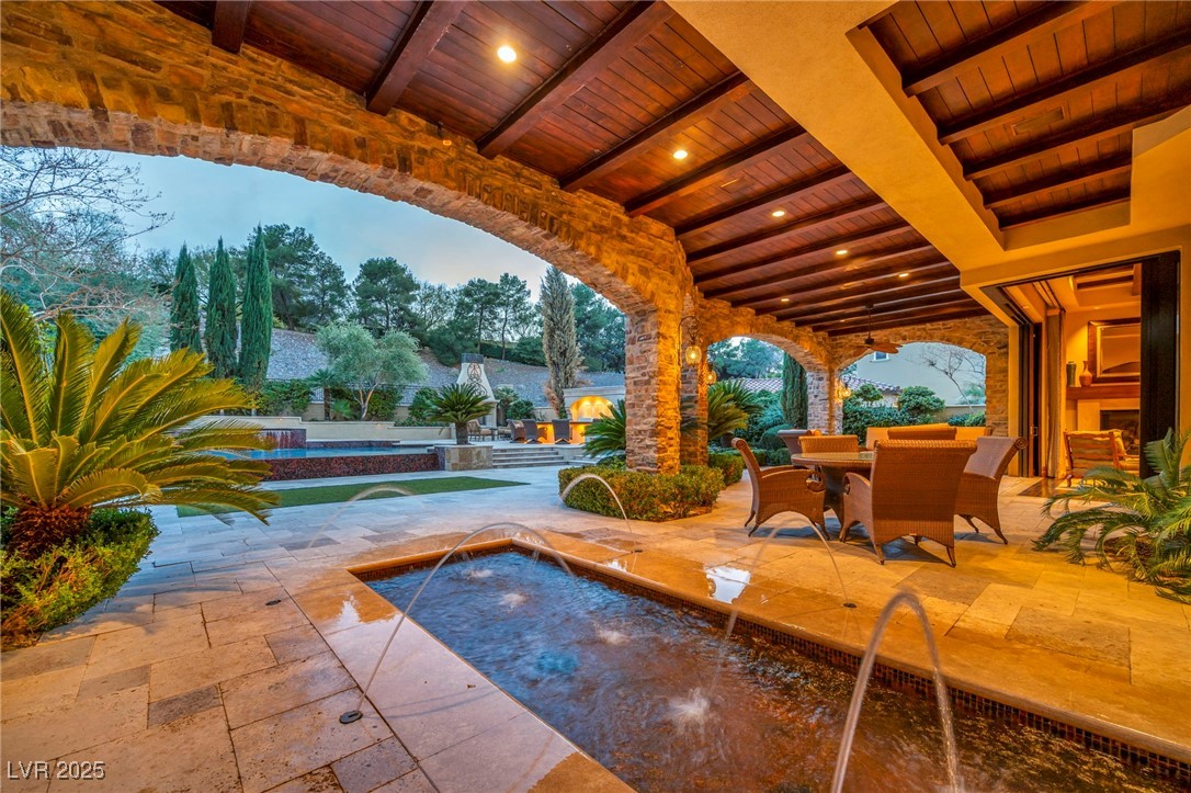 1793 Anelli Court Henderson, NV 89012 - Photo 10 of 47 View of patio / terrace with an outdoor pool, a hot tub, and outdoor dining space