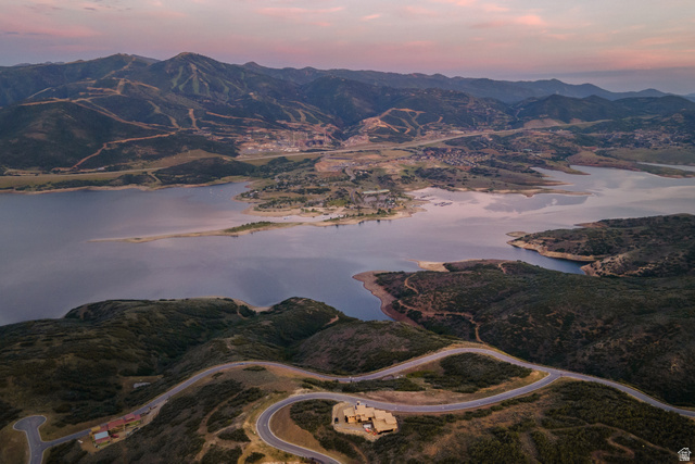 9269 North Sunset Road Kamas, UT 84036 - Photo 17 of 21 Expansive mountain and lake landscape featuring a winding paved road, surrounding natural vegetation, distant structures, and a prominent body of water