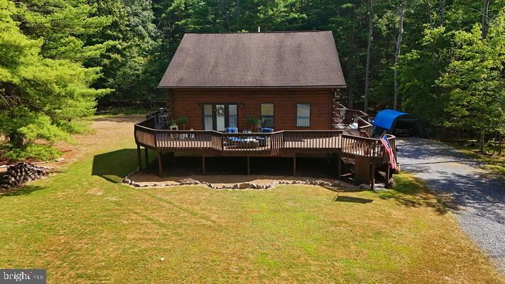 a view of house with swimming pool and sitting area