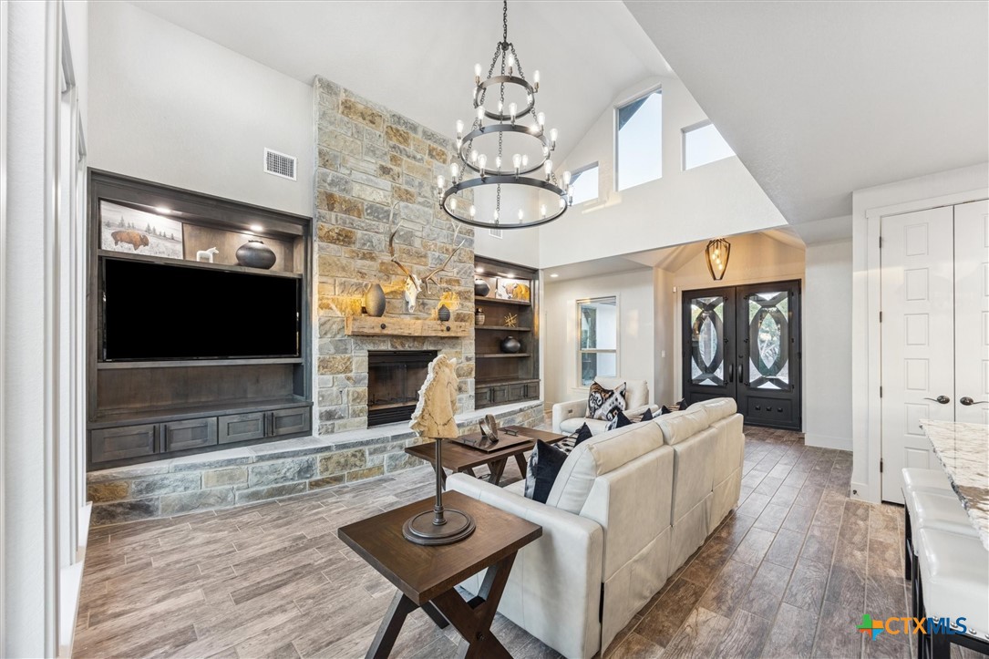 134 Flanders Fischer, TX 78623 - Photo 10 of 37 a living room with furniture a flat screen tv and a fireplace