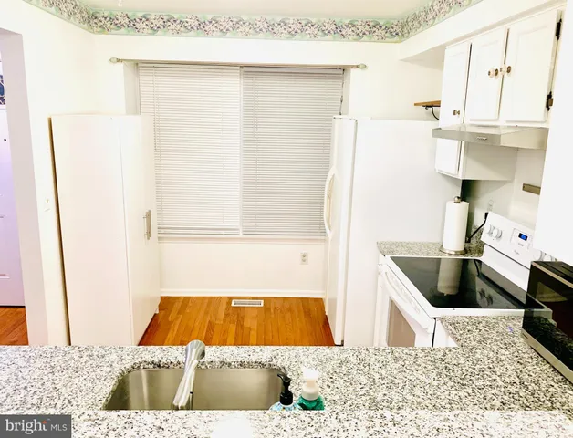 a kitchen with a refrigerator and a sink