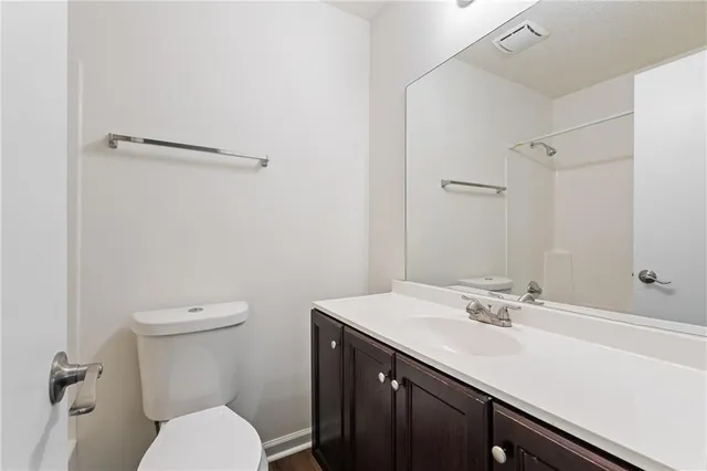 a bathroom with a sink a toilet and a mirror