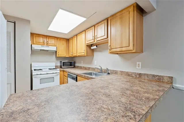 a kitchen with stainless steel appliances granite countertop a sink and cabinets