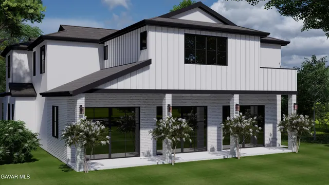 a front view of a house with plants