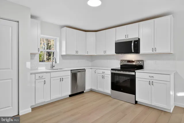 a bedroom with a large bed and a flat screen tv