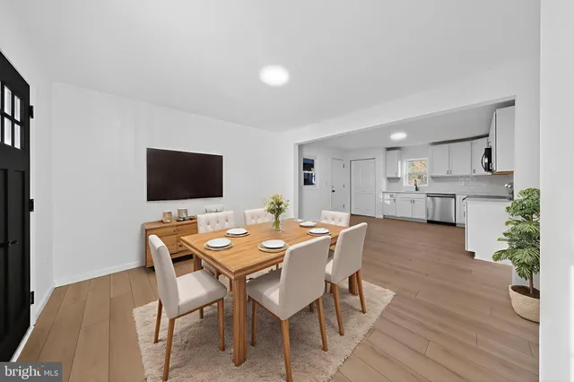 a view of empty room with kitchen and window