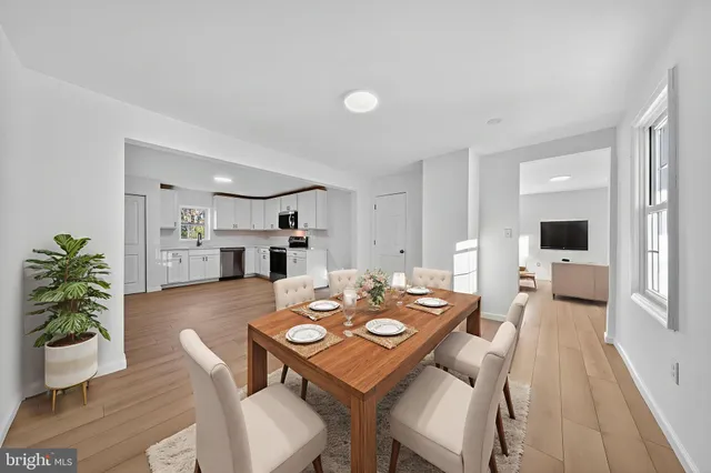 a kitchen with granite countertop a stove top oven a sink dishwasher and a refrigerator with wooden floor