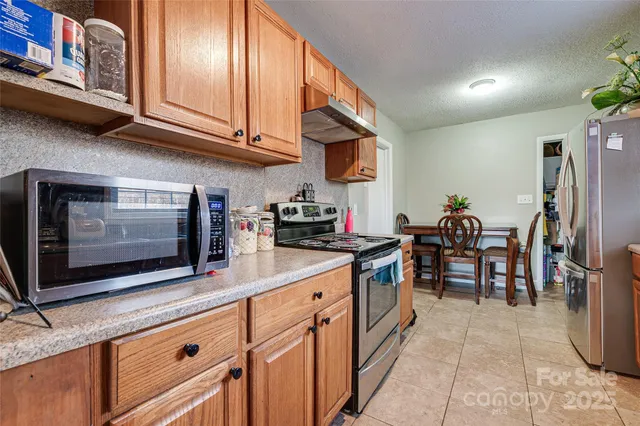 a kitchen with stainless steel appliances granite countertop a stove and cabinets