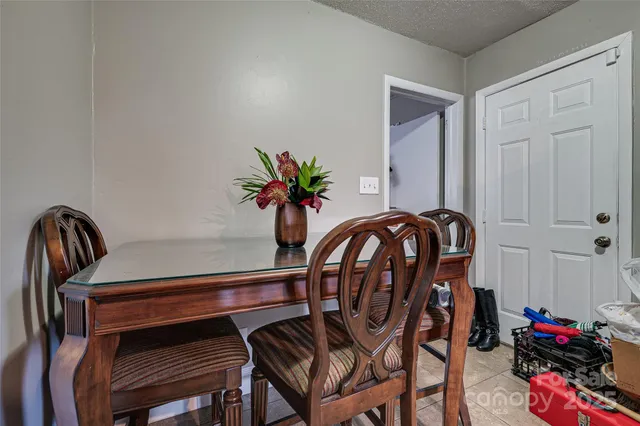 a view of a dining room with furniture and flower pot