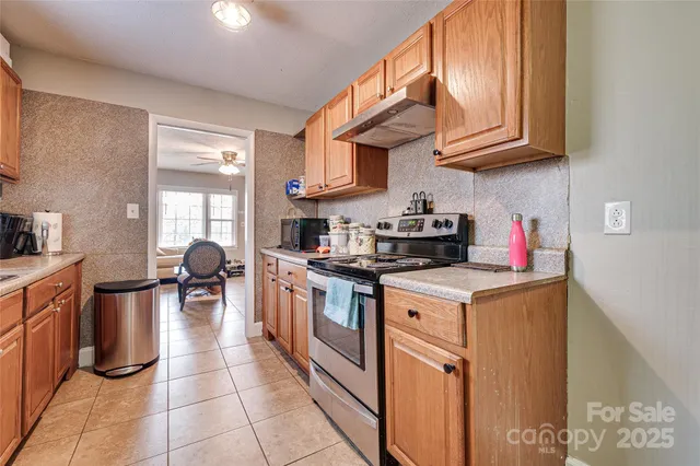 a kitchen with stainless steel appliances granite countertop a stove and a sink