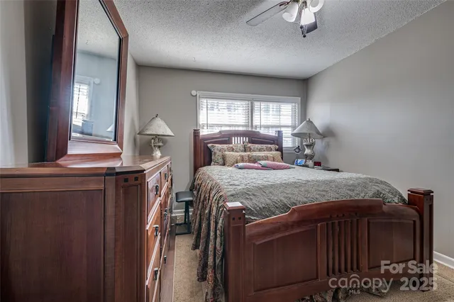 a bedroom with a bed table and window