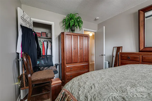 a bedroom with a large bed and a closet