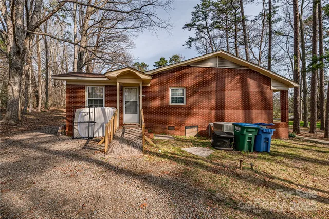 a backyard of a house with barbeque oven table and chairs