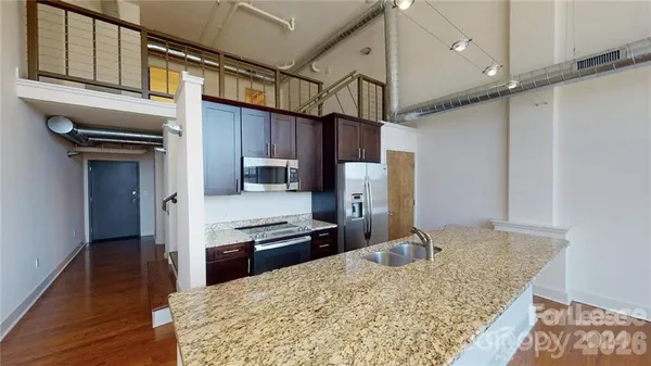 a kitchen with kitchen island a counter top space appliances and cabinets