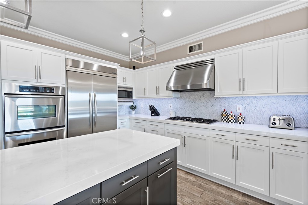 10 Blue Spruce Drive Ladera Ranch, CA 92694 - Photo 16 of 45 a kitchen with cabinets stainless steel appliances and wooden floor