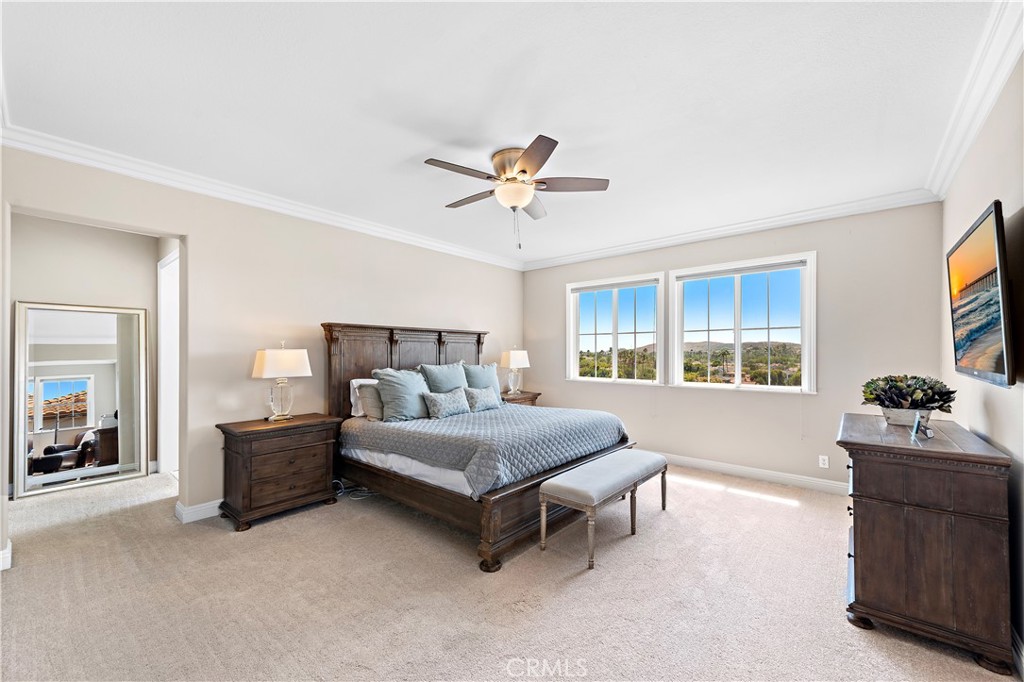 10 Blue Spruce Drive Ladera Ranch, CA 92694 - Photo 21 of 45 a bedroom with a bed and a chandelier