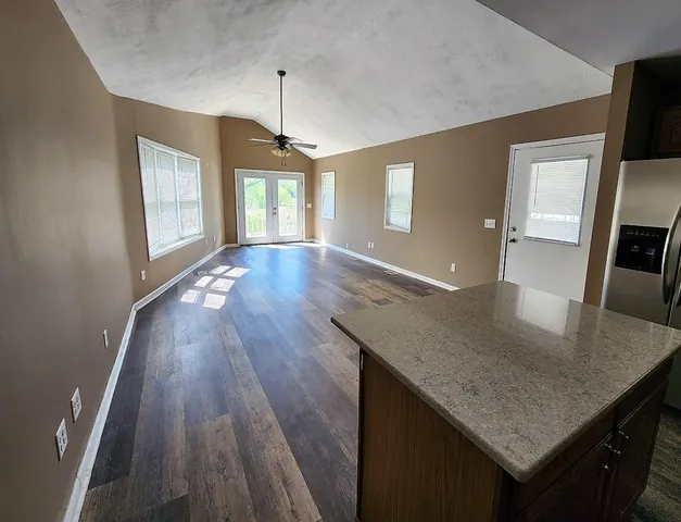a kitchen with kitchen island a counter space a sink and appliances