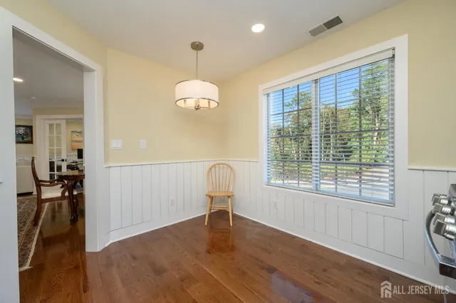 a view of a room with wooden floor and furniture