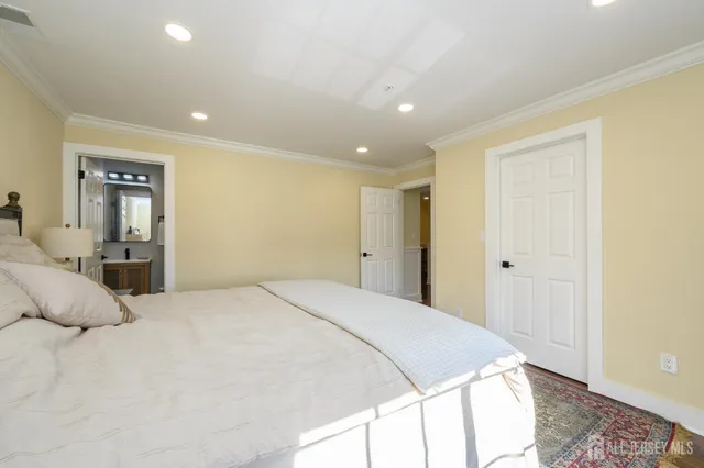 a spacious bedroom with a bed and a couch