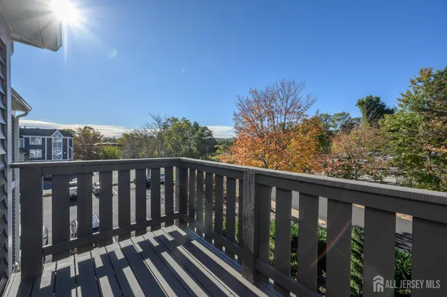 a balcony with wooden floor and fence
