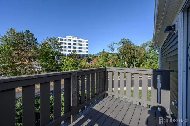a balcony with wooden floor and outdoor space