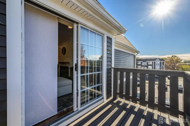 a bathroom with a glass shower door and a rug
