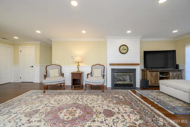 a living room with fireplace furniture and a flat screen tv