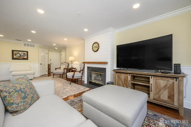a living room with fireplace furniture and a flat screen tv