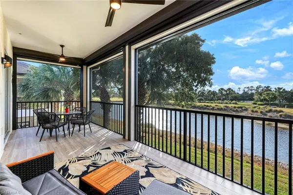 a view of a chairs and table in the balcony