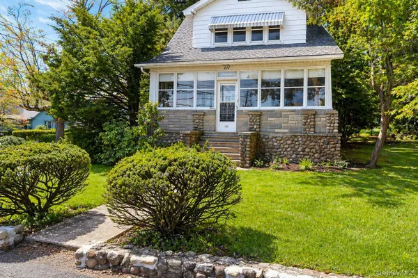 a front view of a house with a garden