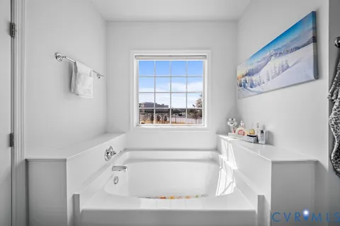 a bathroom with a bathtub and a window