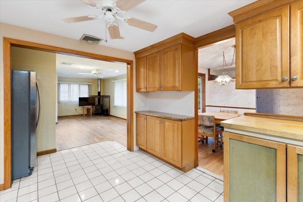 6 Sycamore Street Danvers, MA 01923 - Photo 12 of 30 a kitchen with a refrigerator a sink and a stove top oven