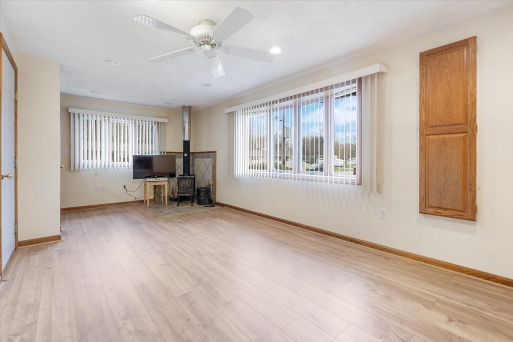 6 Sycamore Street Danvers, MA 01923 - Photo 15 of 30 a view of an empty room with a window and wooden floor