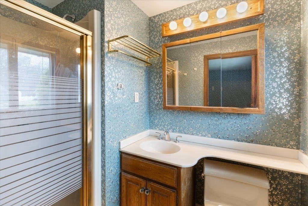 6 Sycamore Street Danvers, MA 01923 - Photo 19 of 30 a bathroom with a sink and a mirror