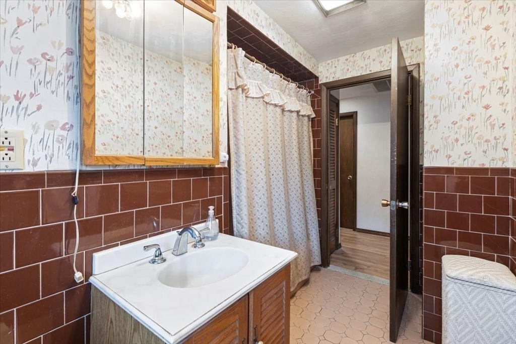 6 Sycamore Street Danvers, MA 01923 - Photo 20 of 30 a bathroom with a sink vanity and a shower