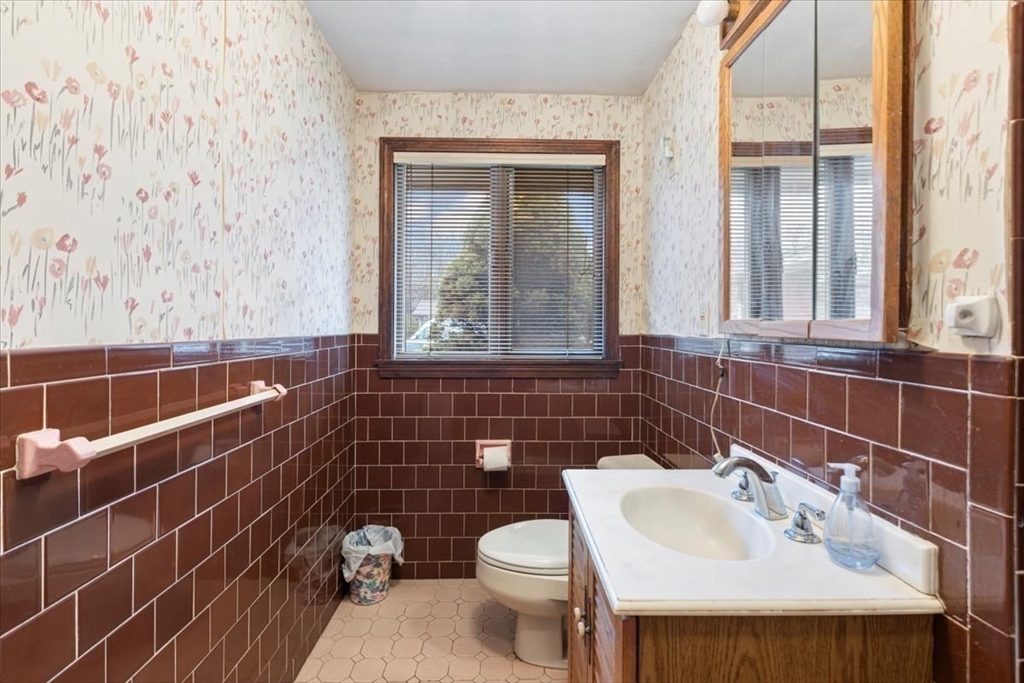 6 Sycamore Street Danvers, MA 01923 - Photo 21 of 30 a bathroom with a sink toilet and mirror