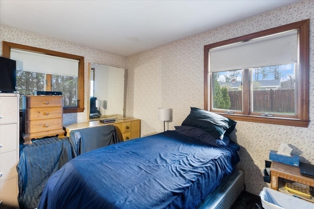 6 Sycamore Street Danvers, MA 01923 - Photo 22 of 30 a bedroom with a bed and wooden floor