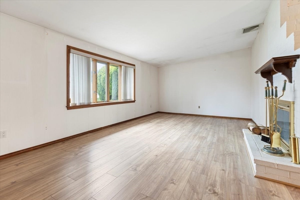 6 Sycamore Street Danvers, MA 01923 - Photo 4 of 30 an empty room with wooden floor and windows