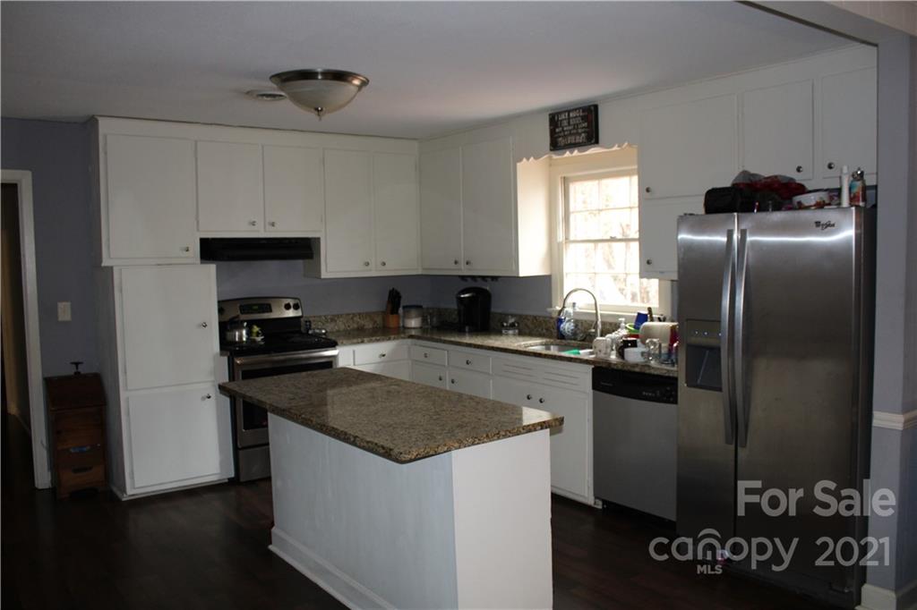 1021 Faith Road Salisbury, NC 28146 - Photo 4 of 12 a kitchen with a refrigerator stove and sink