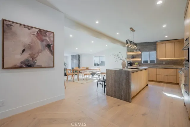 a kitchen with stainless steel appliances kitchen island granite countertop a sink and cabinets