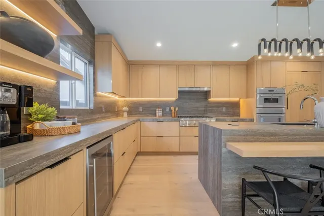 a kitchen with stainless steel appliances granite countertop a stove and a sink
