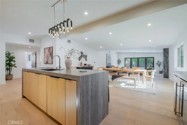a kitchen with kitchen island granite countertop a table and chairs in it