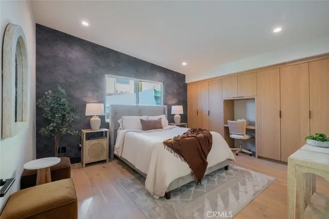 a bedroom with a bed and a large window