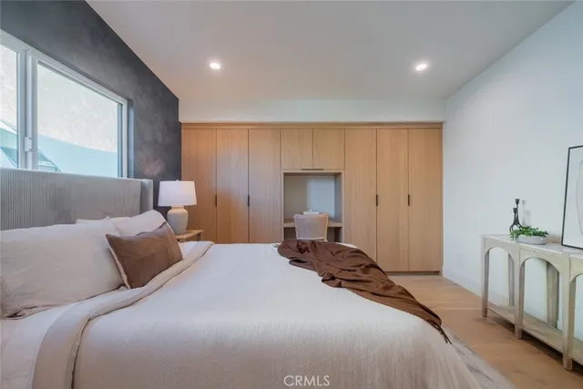 a spacious bedroom with a bed and a potted plant