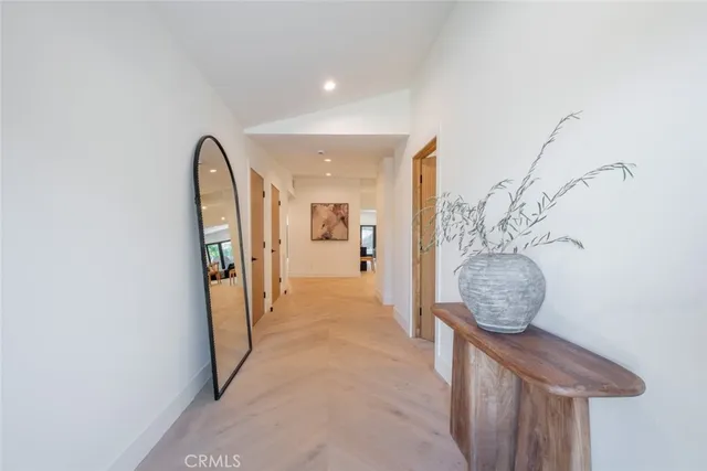 a view of a hallway and wooden floor