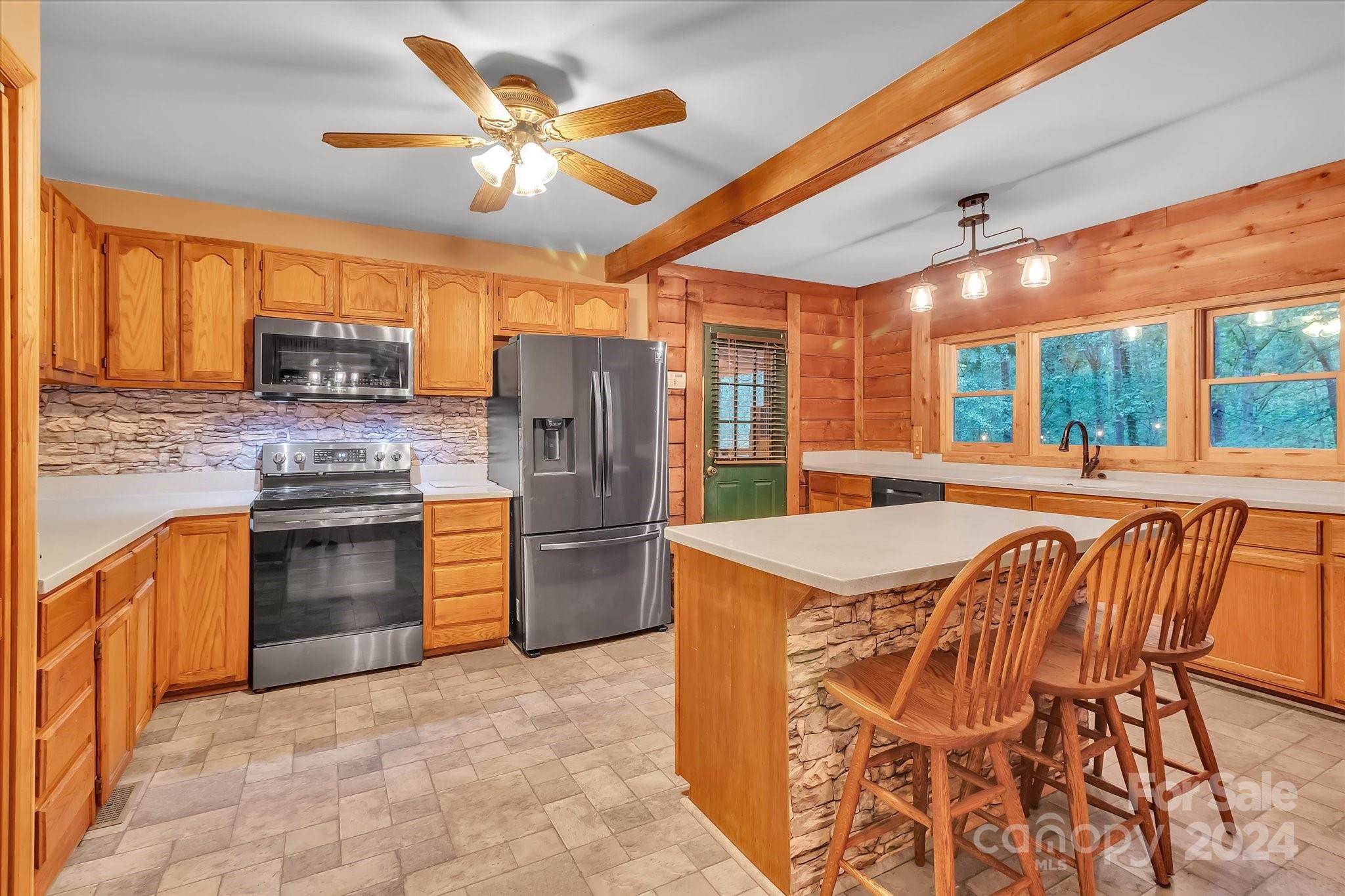 824 Rutledge Drive Catawba, SC 29704 - Photo 13 of 25 a kitchen with stainless steel appliances granite countertop a stove a refrigerator a oven a sink with a dining table and chairs