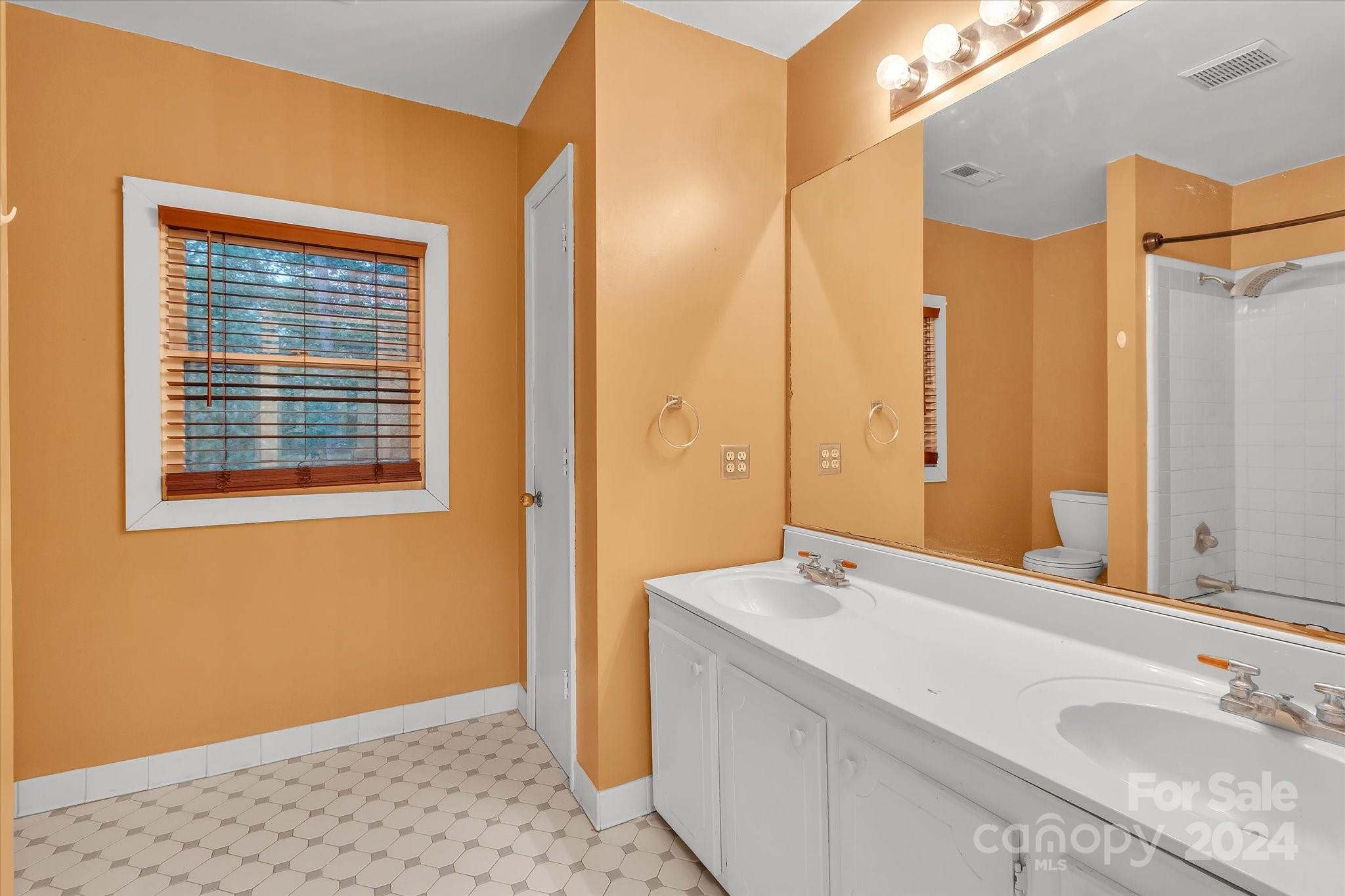 824 Rutledge Drive Catawba, SC 29704 - Photo 19 of 25 a bathroom with a granite countertop sink and a mirror